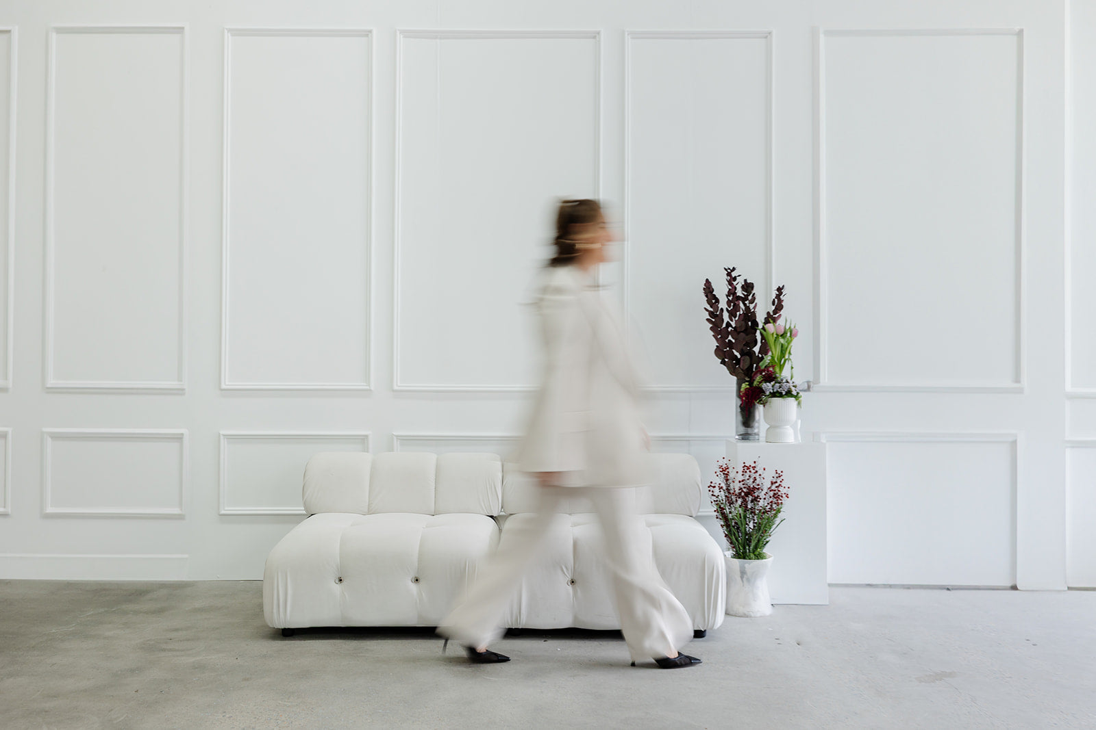White Couch Flowers Woman Walking